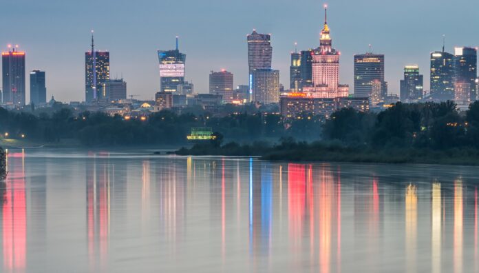 Night panorama of Warsaw skyline, Poland, over Vistula river in the night